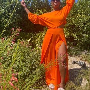 A cropped off shoulder bell sleeve top with high waisted split flowy pan…